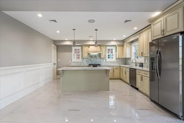 a kitchen with a refrigerator sink and cabinets