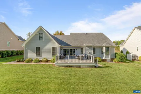 a front view of a house with a yard table and chairs