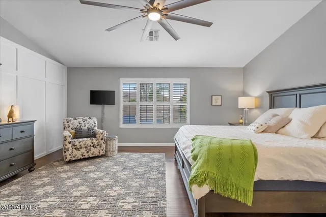 a bedroom with a bed couch and window