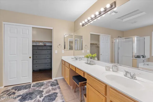 a bathroom with a granite countertop sink a toilet a mirror and shower