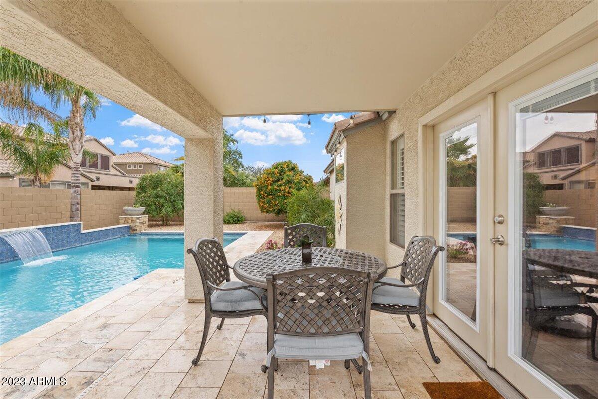 15257 West Hearn Road Surprise, AZ 85379 - Photo 2 of 37 a dining room with furniture and wooden floor