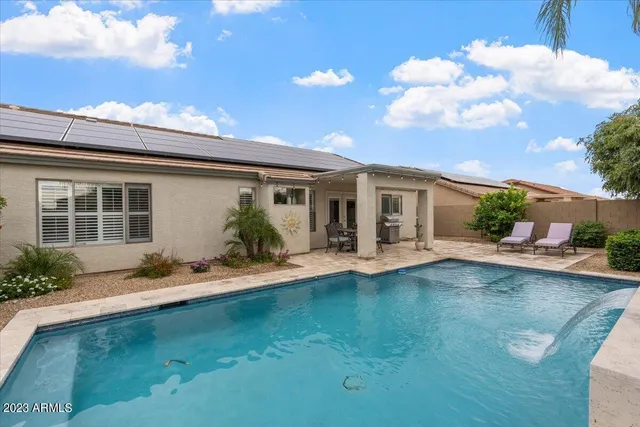 a view of house with a yard and potted plants
