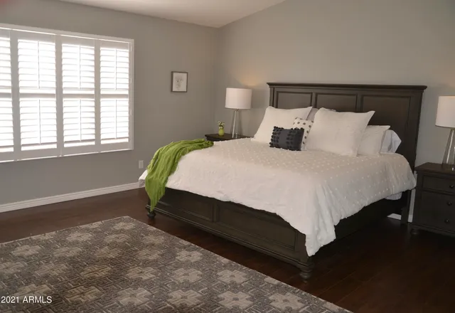 a view of a chair and table in backyard with potted plants