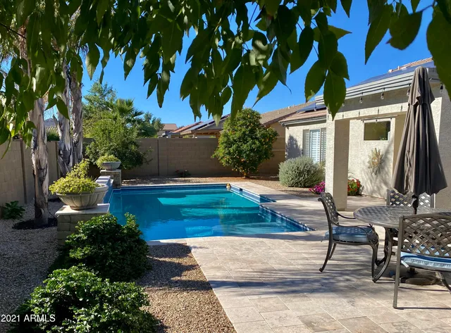 a bathroom with a granite countertop sink vanity and mirror