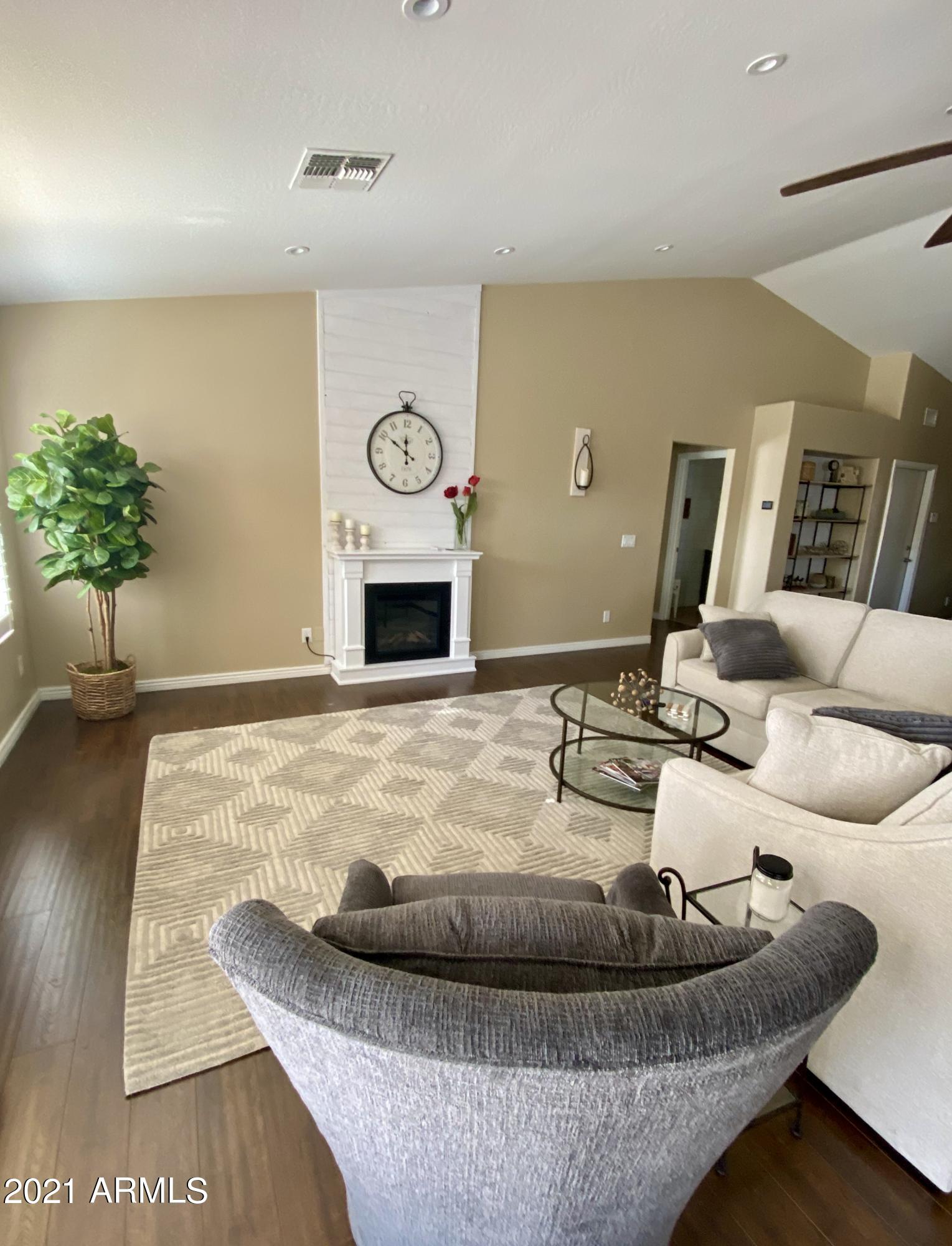 15257 West Hearn Road Surprise, AZ 85379 - Photo 36 of 37 a living room with furniture and a wooden floor