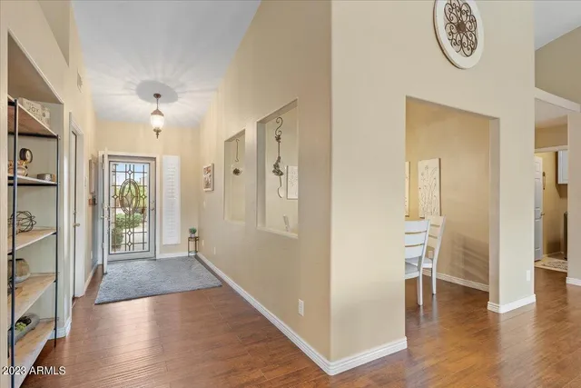 a view of a hallway with wooden floor