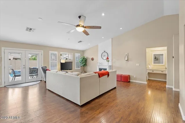 a living room with furniture and a wooden floor