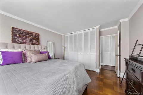 a bedroom with a large bed and a tv