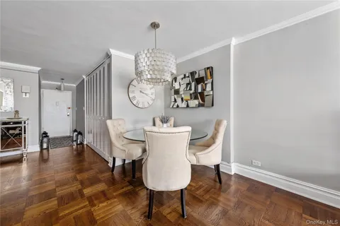 a view of a dining room with furniture wooden floor and chandelier