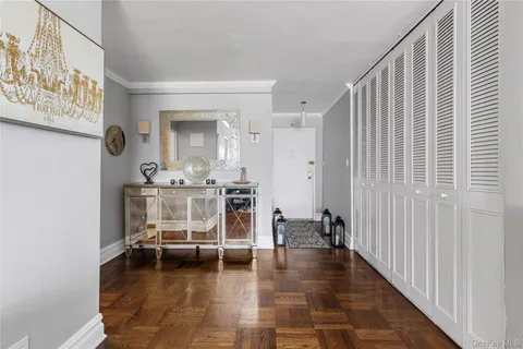 a view of a hallway with wooden floor and dining room