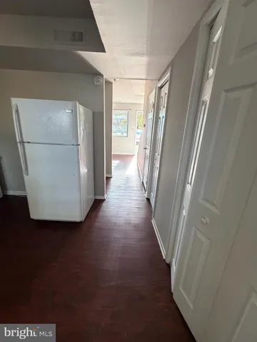 a view of a kitchen from a hallway