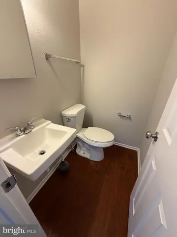 a bathroom with a sink mirror and toilet