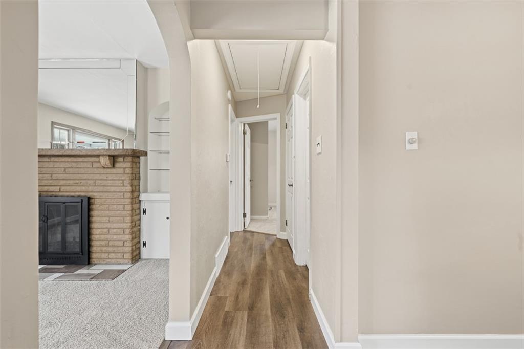 268 Coraopolis Road Coraopolis, PA 15108 - Photo 12 of 50 This is the hallway leading the the 2nd and 3rd bedrooms and the full bathroom. New luxury vinyl tile flooring meets new carpet in the bedroom you see! Note there is a pull down attic access, that is convenient for storage.