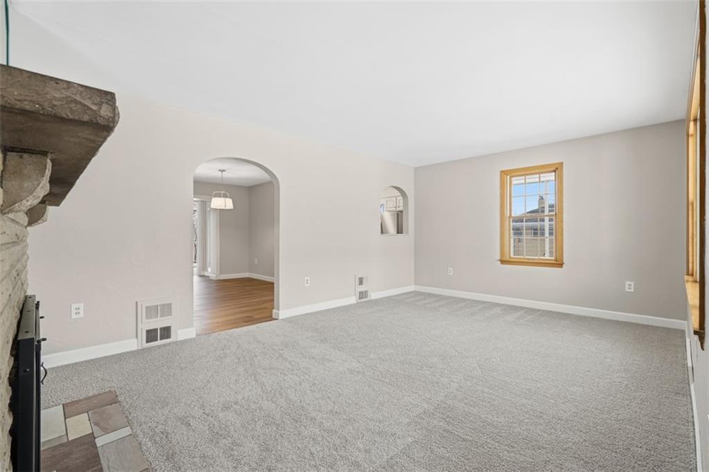 268 Coraopolis Road Coraopolis, PA 15108 - Photo 9 of 50 The 20x12 living room is a great space to gather together and watch a movie or host a game night! You can see into the dining room here, and beyond that is the primary bedroom with balcony.