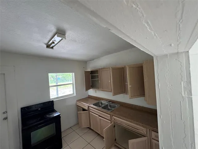 a kitchen that has a stove and a sink