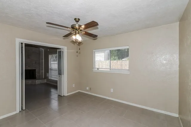 a view of a livingroom with a ceiling fan and window