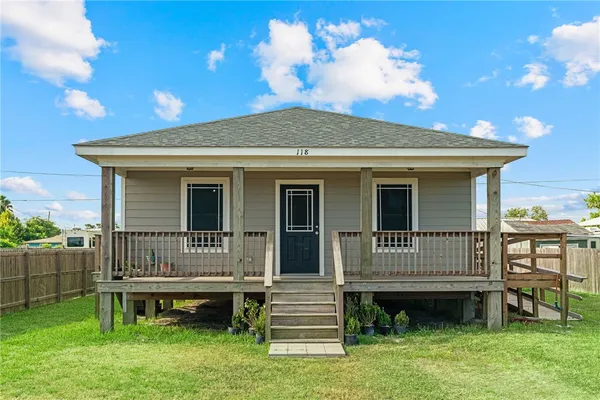 a front view of a house with a garden and deck