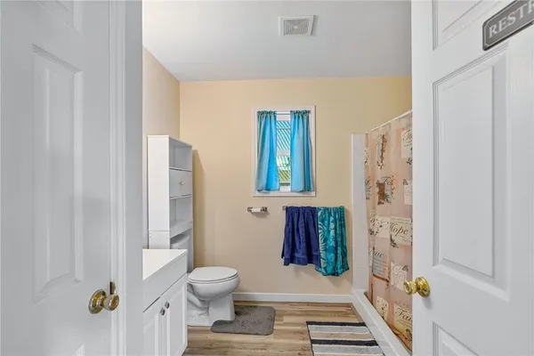 a bathroom with a toilet and a shower