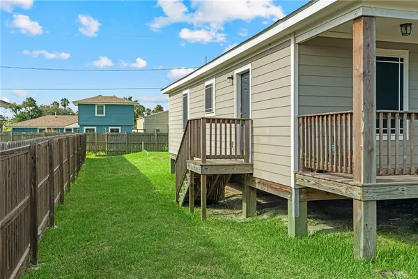 a view of house with backyard and deck