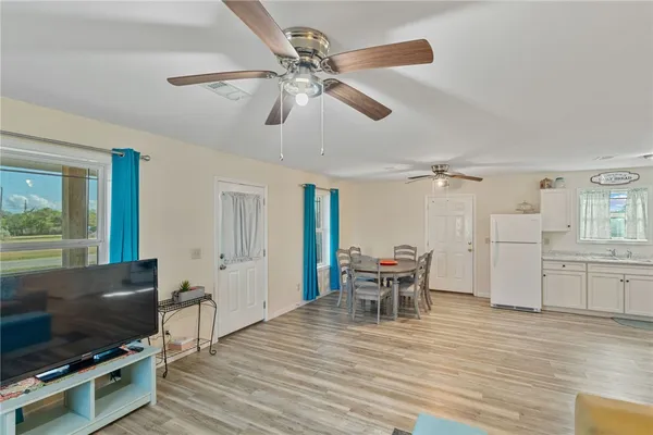 a view of a dining room with furniture and wooden floor