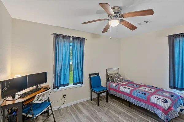 a bedroom with a bed and a chair