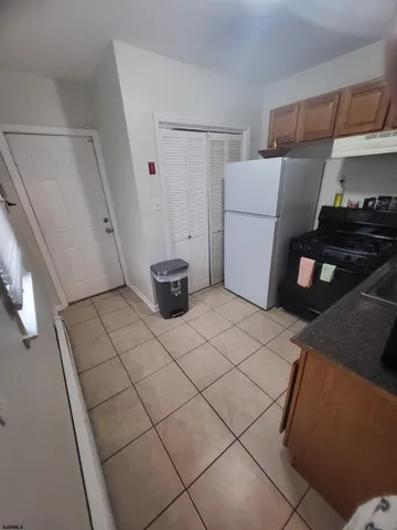 a kitchen with a sink and a refrigerator