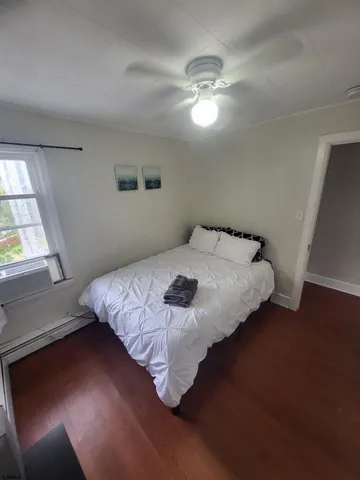 a bedroom with a bed and window