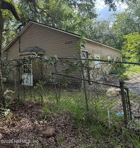 a backyard of a house with lots of green space
