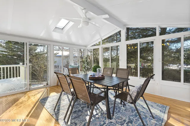 a view of a dining room with furniture wooden floor and chandelier