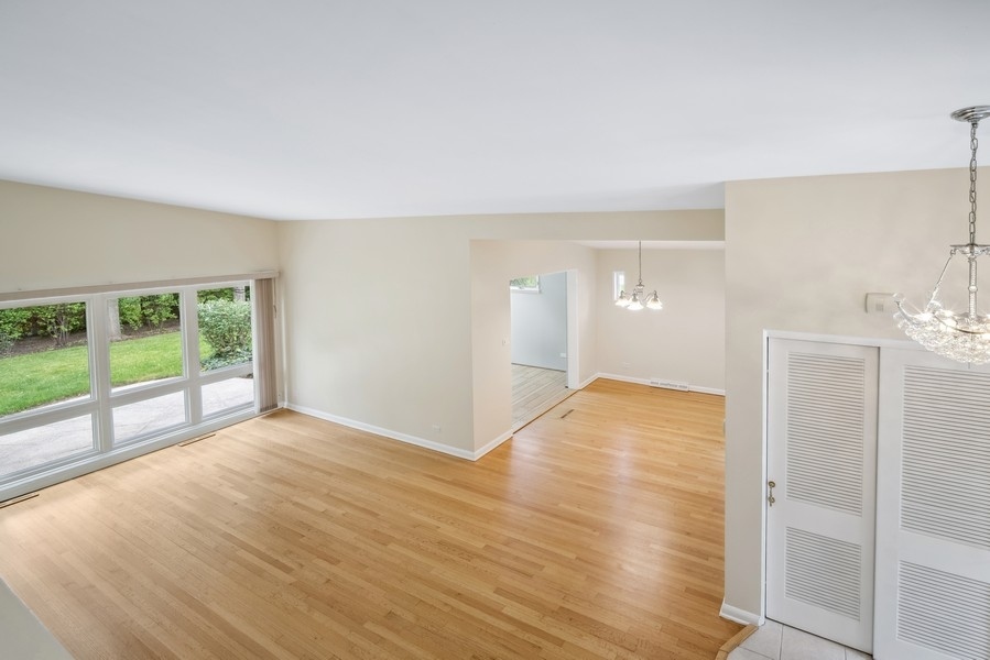 401 Locust Road Wilmette, IL 60091 - Photo 3 of 32 wooden floor in an empty room with a window