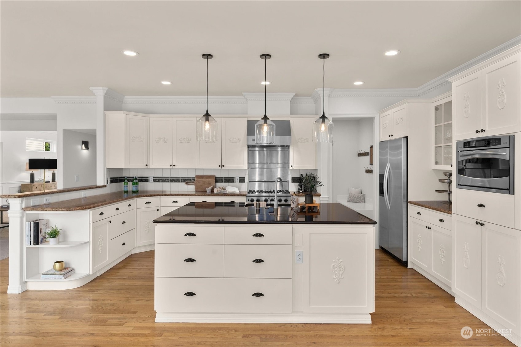1509 242nd Street Southeast Bothell, WA 98021 - Photo 11 of 40 a kitchen with stainless steel appliances kitchen island granite countertop a stove a sink and a refrigerator