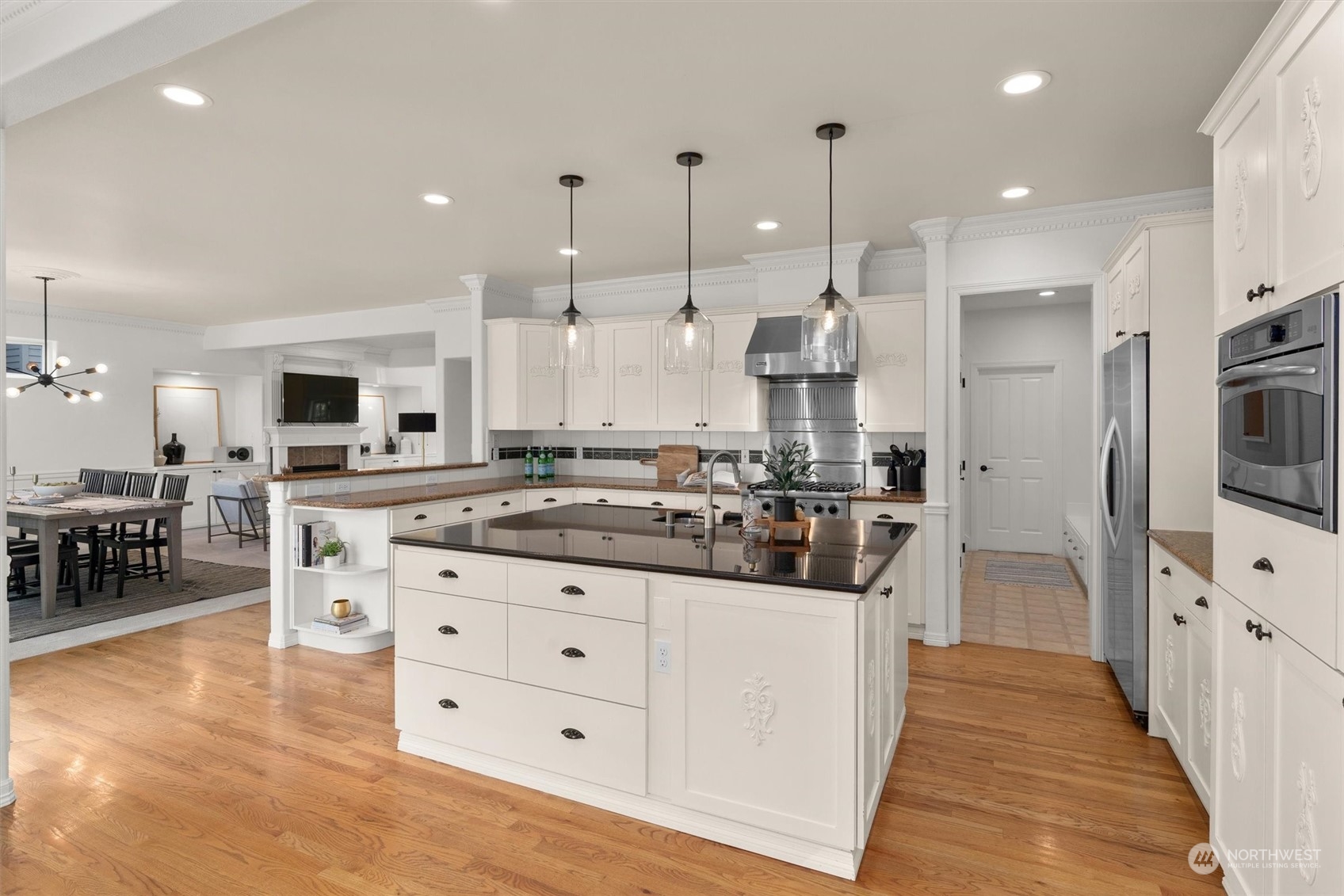 1509 242nd Street Southeast Bothell, WA 98021 - Photo 13 of 40 a kitchen with stainless steel appliances kitchen island granite countertop a stove and a sink