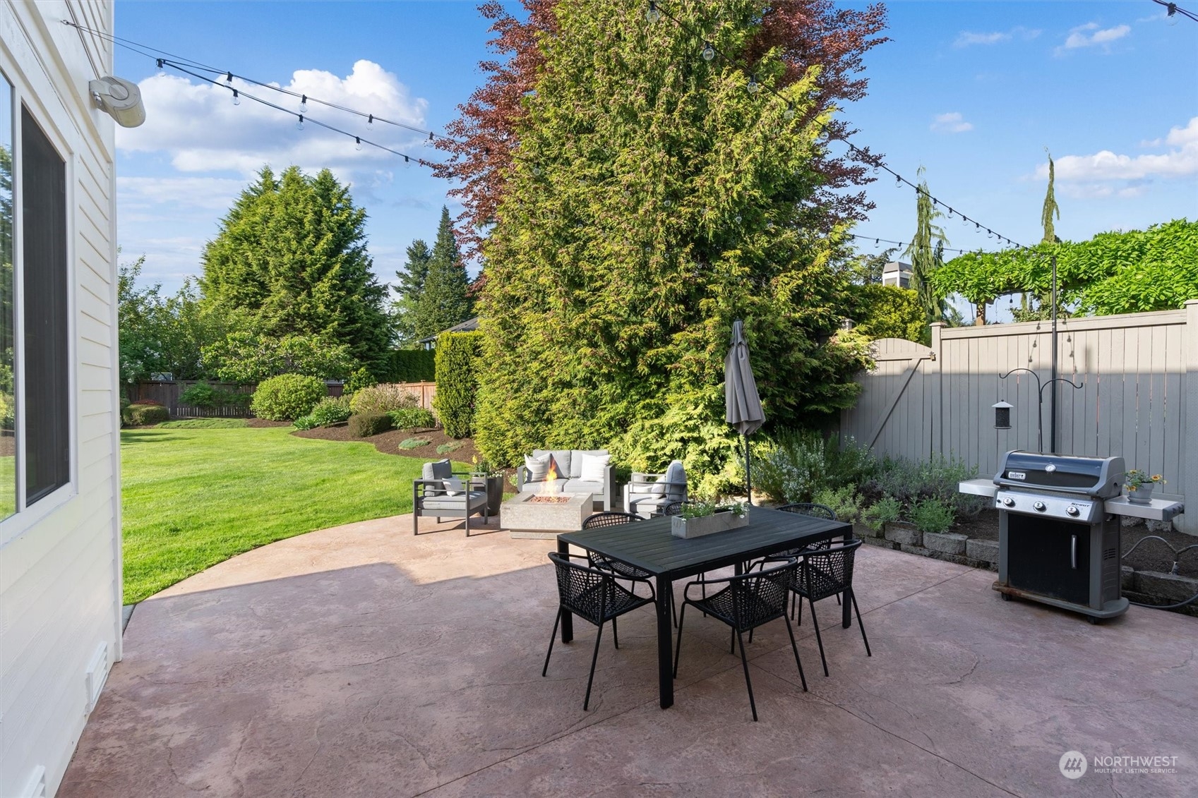 1509 242nd Street Southeast Bothell, WA 98021 - Photo 31 of 40 a view of a chairs and table in backyard of the house