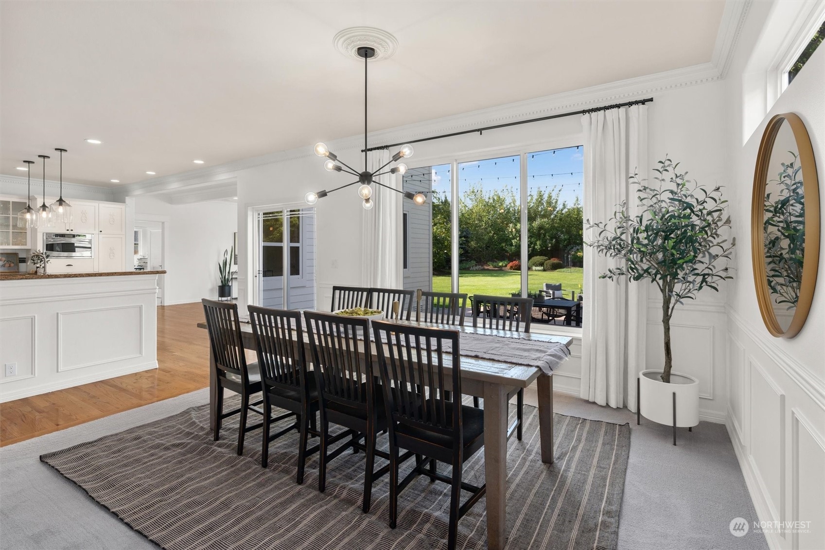 1509 242nd Street Southeast Bothell, WA 98021 - Photo 10 of 40 a view of a dining room and a furniture wooden floor a chandelier