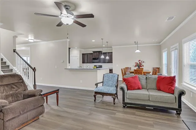 a living room with furniture and a wooden floor