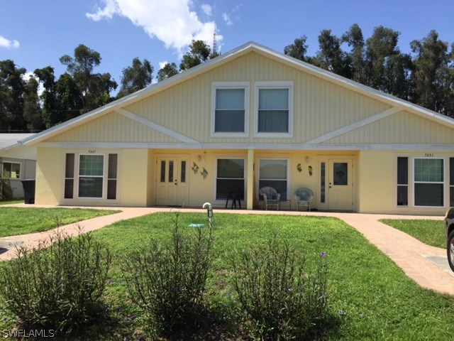 7251 Albany Road Fort Myers, FL 33967 - Photo 1 of 23 a front view of a house with a yard