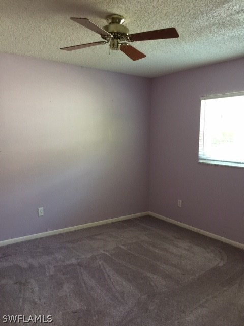 7251 Albany Road Fort Myers, FL 33967 - Photo 17 of 23 an empty room with a ceiling fan and window