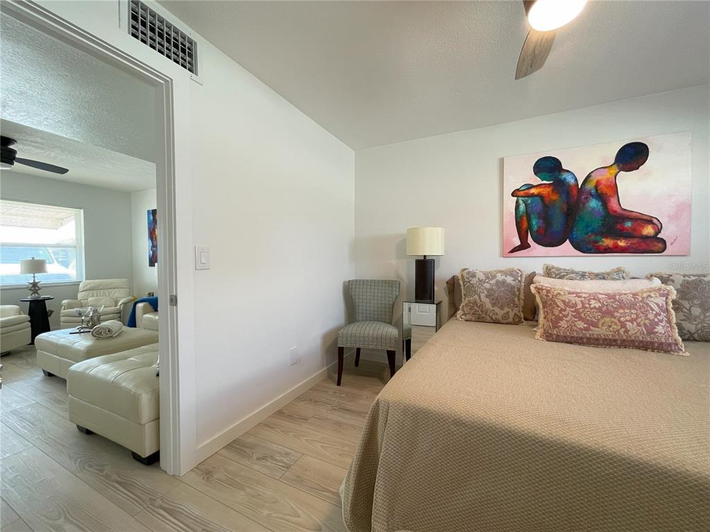 250 Rosery Road Northwest, Unit 329 Largo, FL 33770 - Photo 12 of 27 a bedroom with bed and window