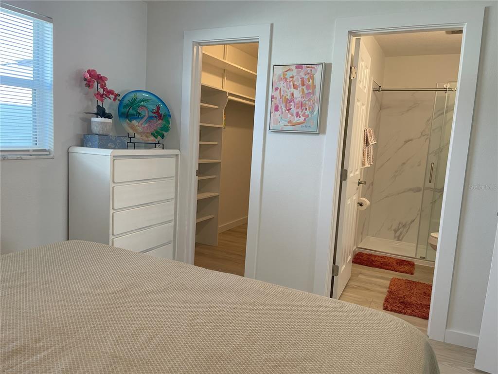 250 Rosery Road Northwest, Unit 329 Largo, FL 33770 - Photo 14 of 27 a bedroom with a bed and a dresser