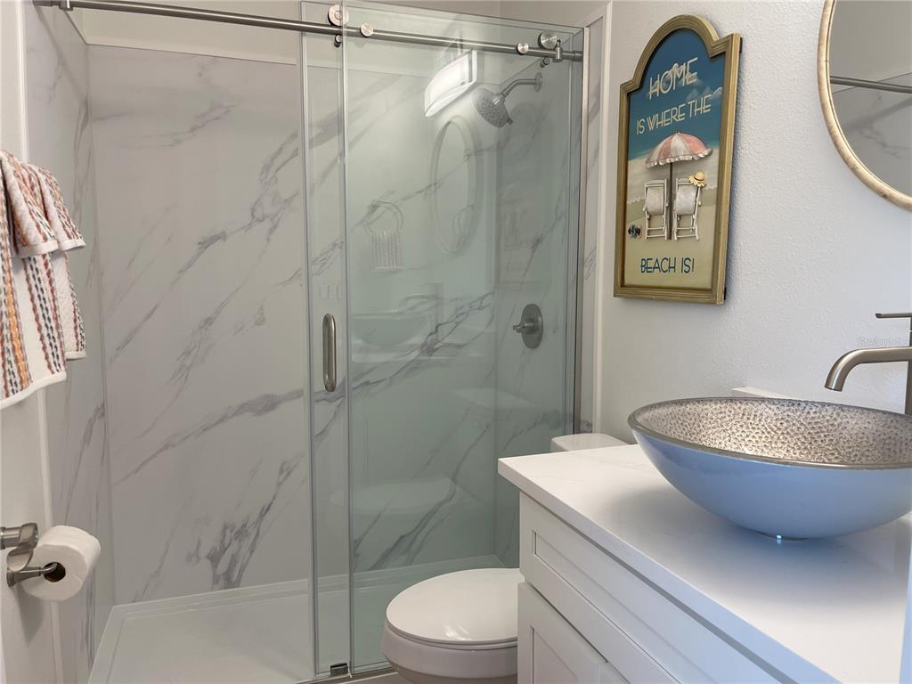 250 Rosery Road Northwest, Unit 329 Largo, FL 33770 - Photo 18 of 27 a bathroom with a toilet a sink and shower