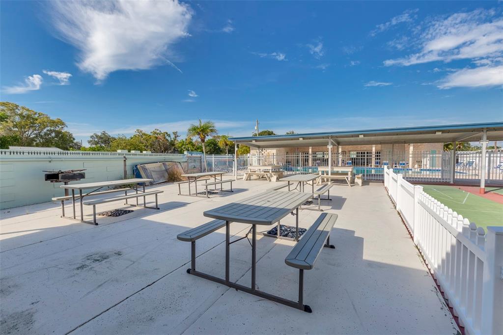250 Rosery Road Northwest, Unit 329 Largo, FL 33770 - Photo 25 of 27 a view of a terrace with furniture and city view