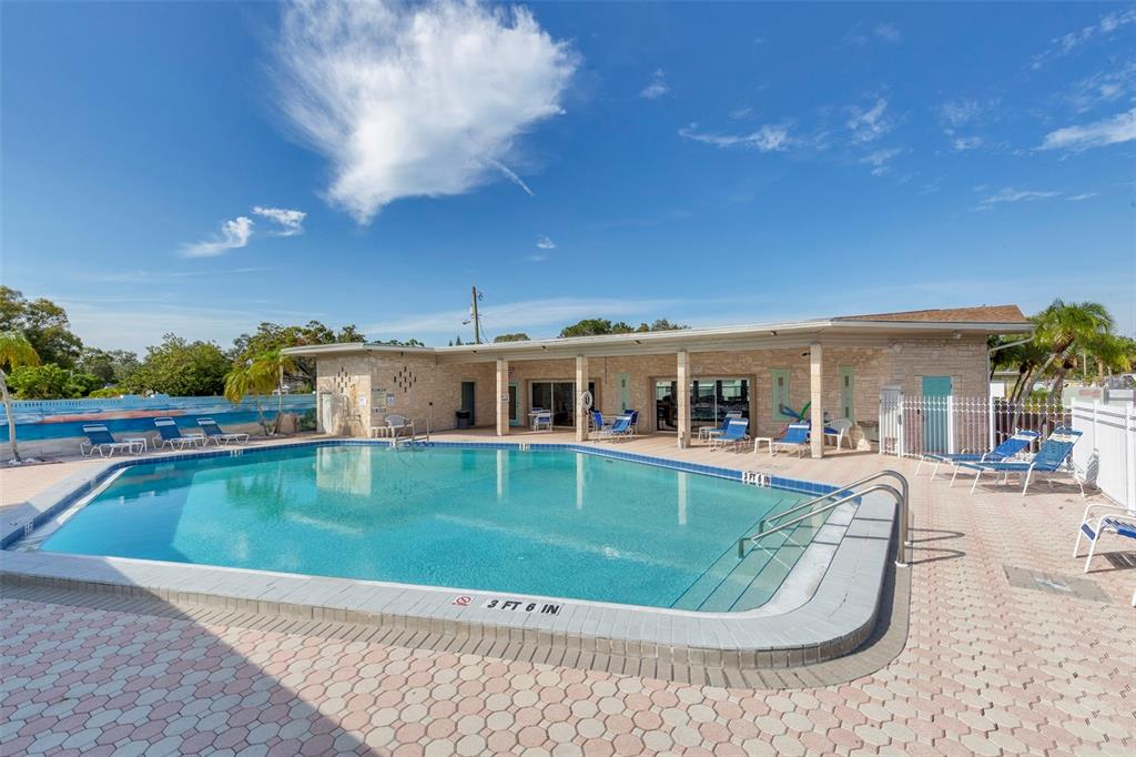250 Rosery Road Northwest, Unit 329 Largo, FL 33770 - Photo 27 of 27 swimming pool view with a seating space and a garden