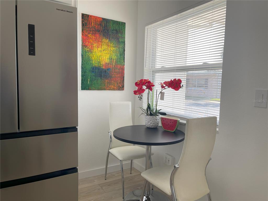 250 Rosery Road Northwest, Unit 329 Largo, FL 33770 - Photo 5 of 27 a dining room with furniture and window