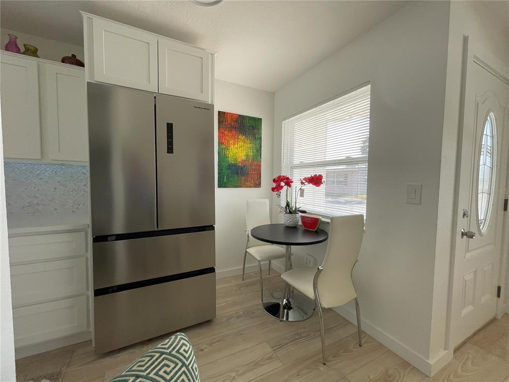 250 Rosery Road Northwest, Unit 329 Largo, FL 33770 - Photo 6 of 27 a kitchen with stainless steel appliances a refrigerator and a sink