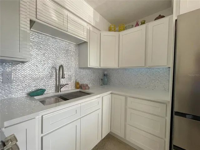 a kitchen with a sink and cabinets