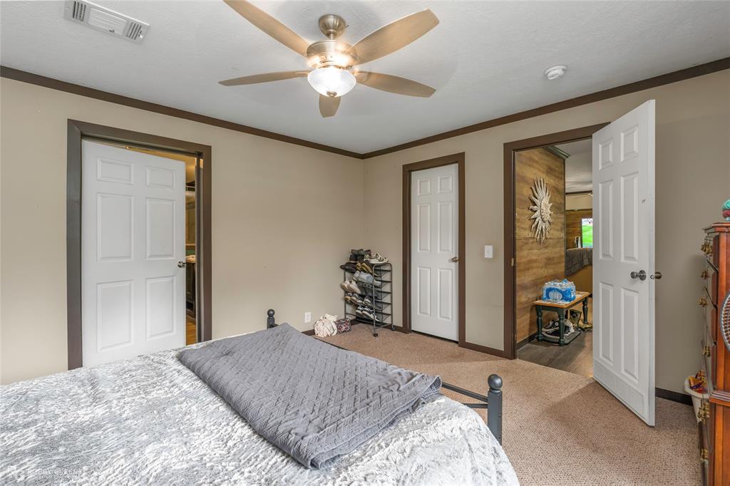 9489 Capps City Road Rodessa, LA 71069 - Photo 13 of 24 Ceiling fan with integrated lighting, recessed lighting, neutral wall tones, white interior doors, and wood-finish flooring