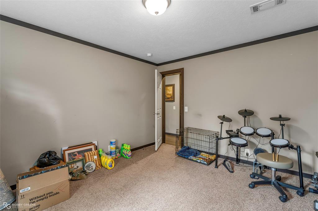 9489 Capps City Road Rodessa, LA 71069 - Photo 19 of 24 Carpeted room with neutral wall color and dark trim
