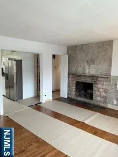 a view of an empty room with a fireplace