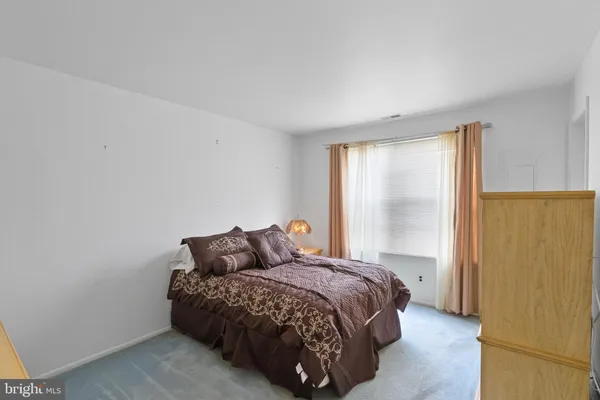 a bathroom with a granite countertop sink mirror vanity and toilet