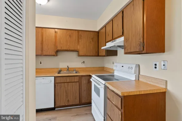 a view of a hallway with a window and wooden floor